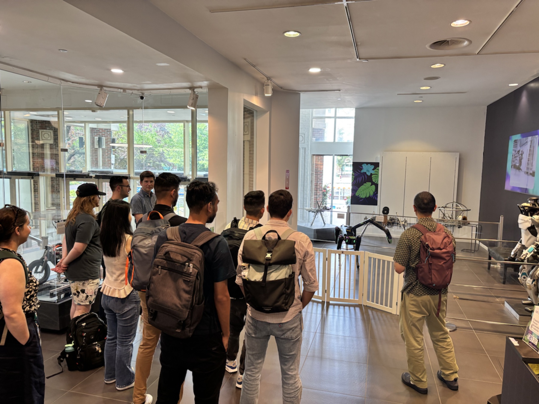 A crowd watching the tropical-patterned Spot robot at the Robot Lab